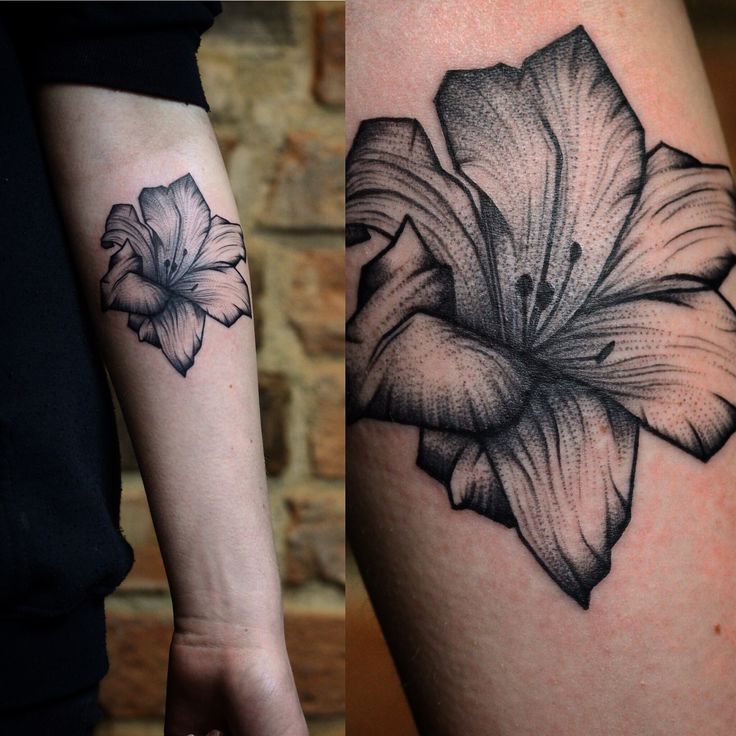 Arm Tattoo with a Water Lily Design in a Gothic Style
