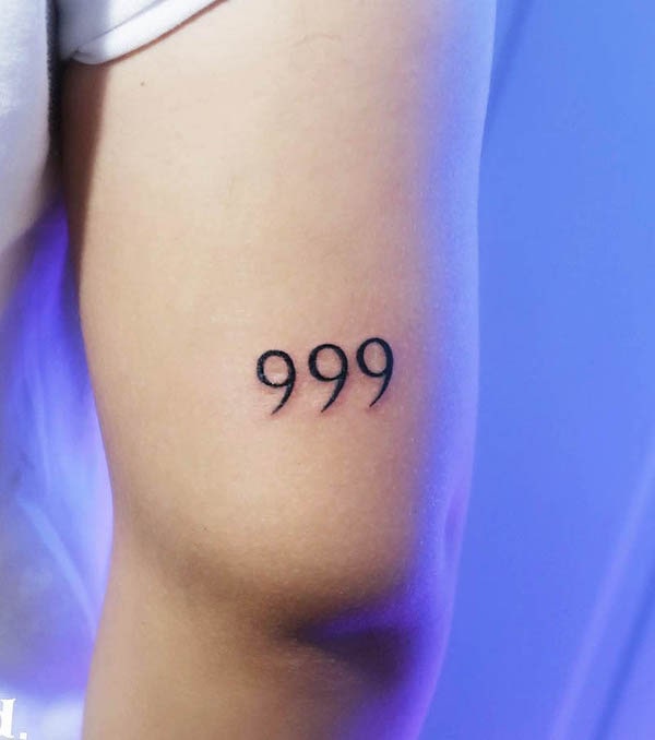 Tattoo of the number 999 on the upper arm